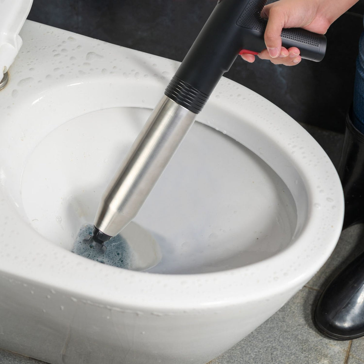 Person cleaning a toilet bowl with a brush