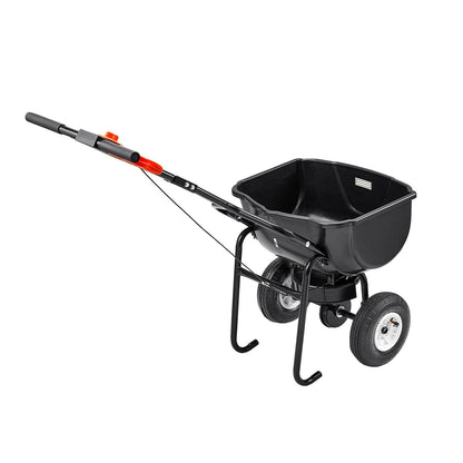 Black fertilizer spreader on a white background