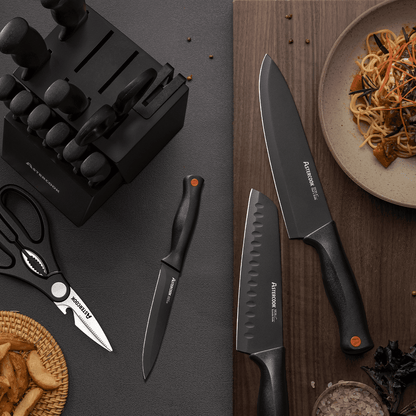 Knives and a knife block on a dark surface with a plate of food.