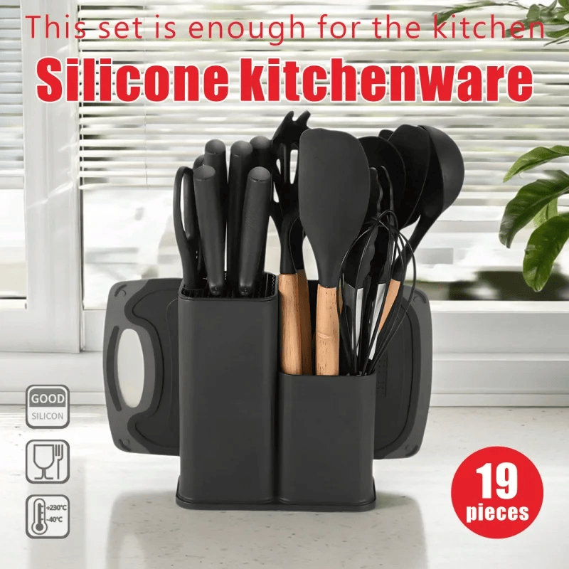 Black silicone kitchen utensil set with holder on a light background