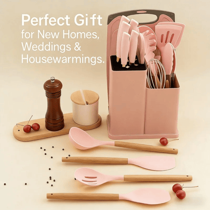 Pink kitchen utensil set with light wood handles, displayed with a pink storage organizer, a dark wooden pepper mill, and cherry props on a warm cream background. Text on the image reads: 'Perfect Gift for New Homes, Weddings & Housewarmings.